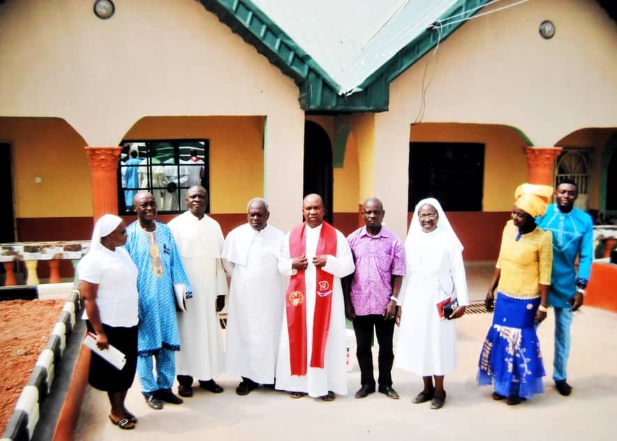 Group of adults standing outside a building
