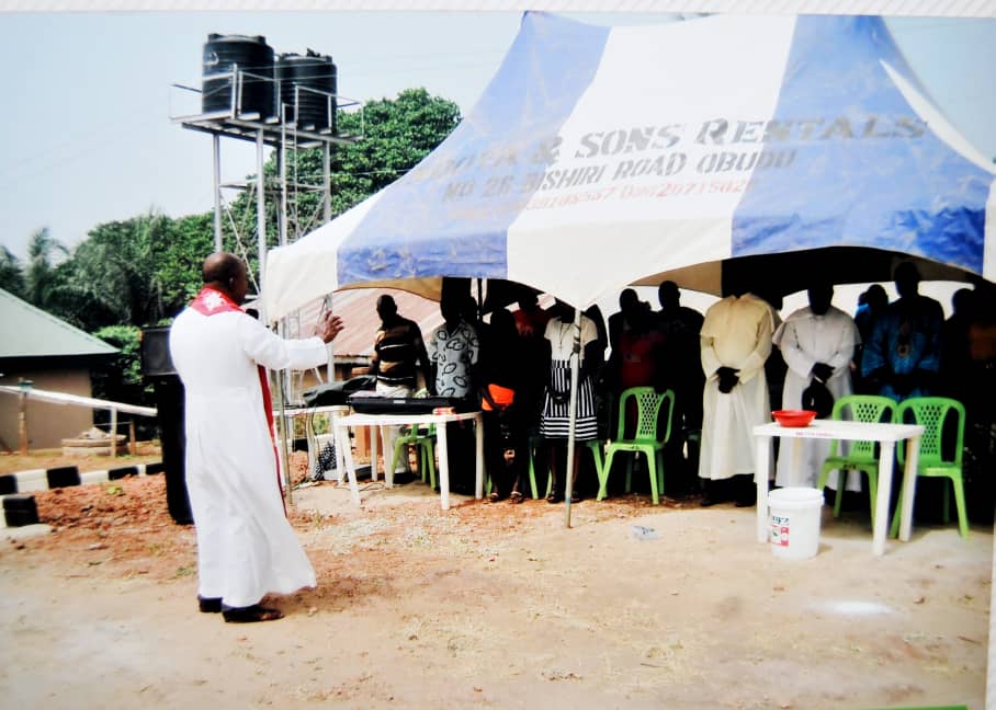Outdoor tent gathering beside a client-supplied building