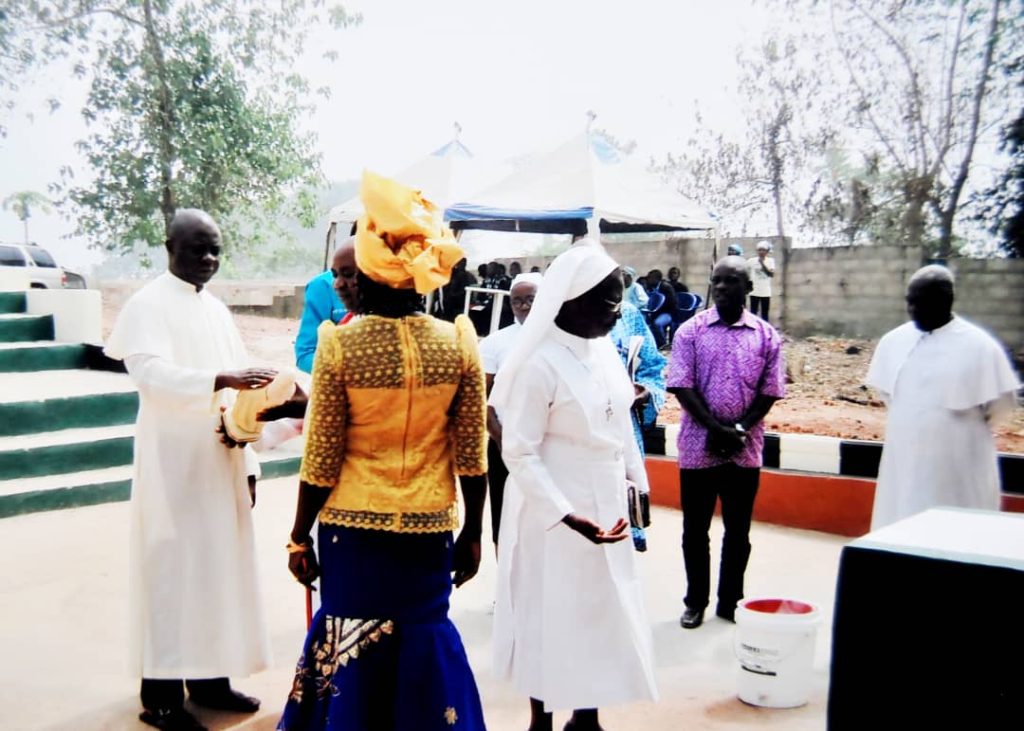 Adults gathered outdoors during a ceremony