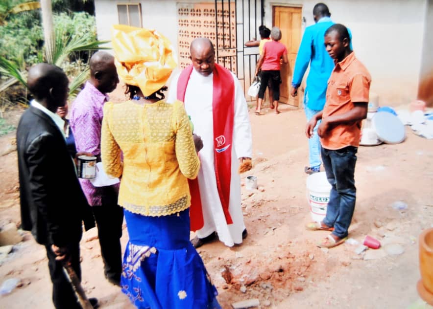 Adults gathered near a building entrance