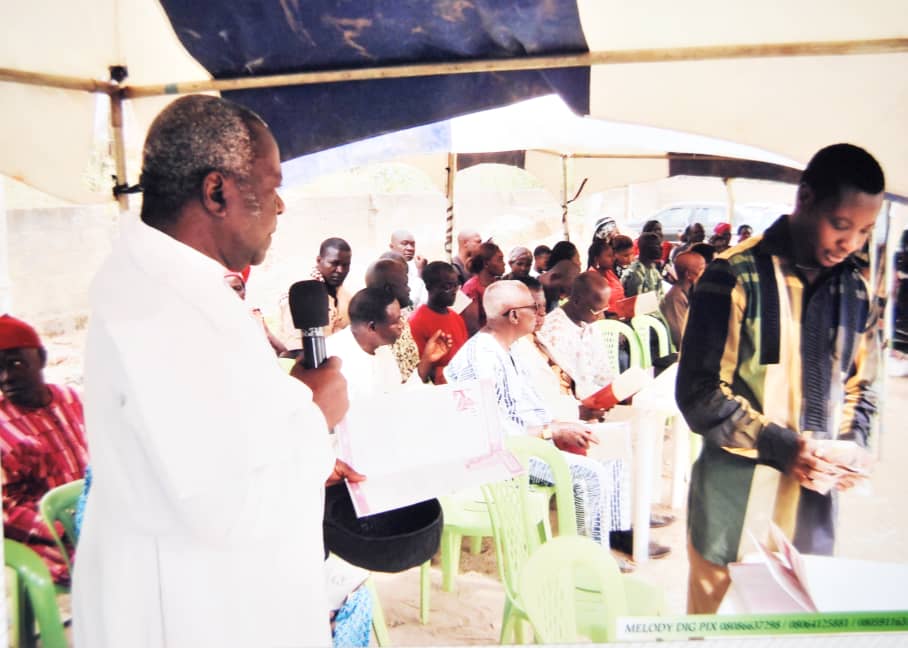 People seated under a tent during a gathering