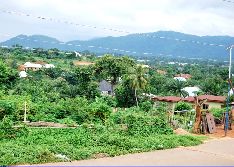 Green hills and homes in a Nigerian landscape