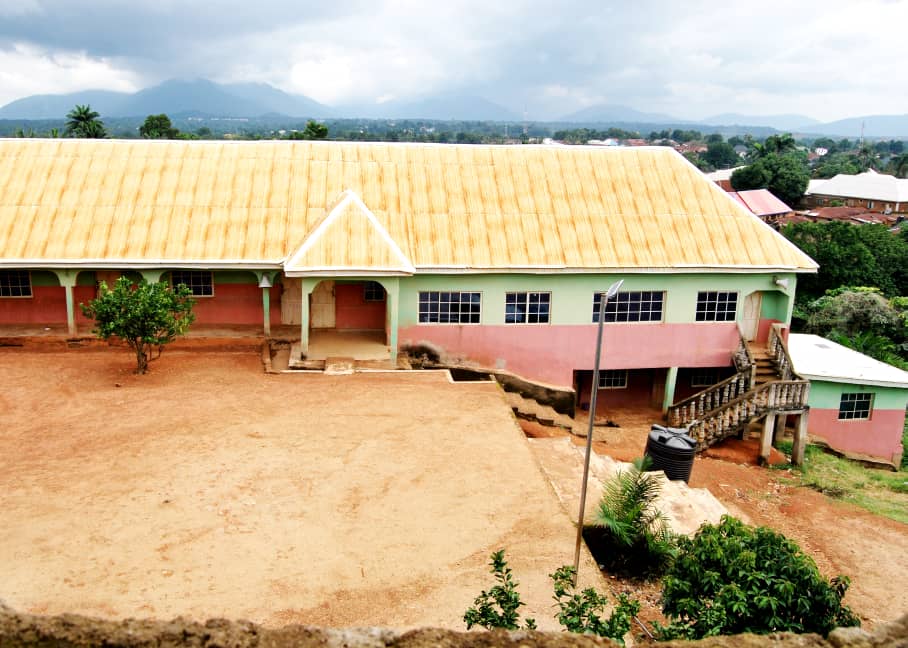 A large building with hills in the distance