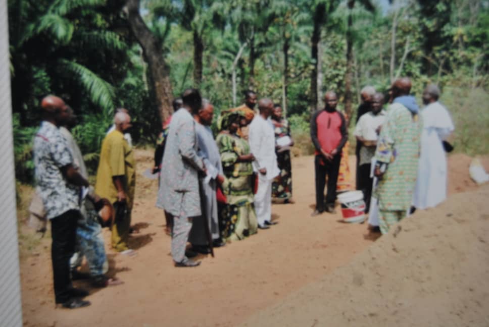 Adults gathered outdoors near a site activity